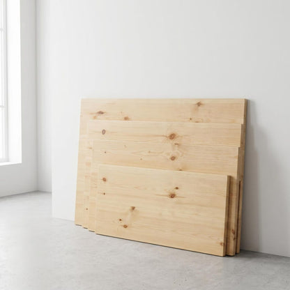 Stack of four light-colored wooden boards with natural grain and knots