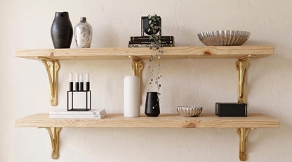 Two natural wood shelves with gold-toned brackets holding vases and plants