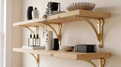 Two natural wood shelves with polished brass brackets