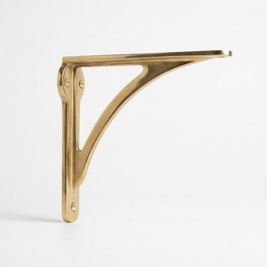 Solid brass shelf bracket with polished finish and curved Victorian arm