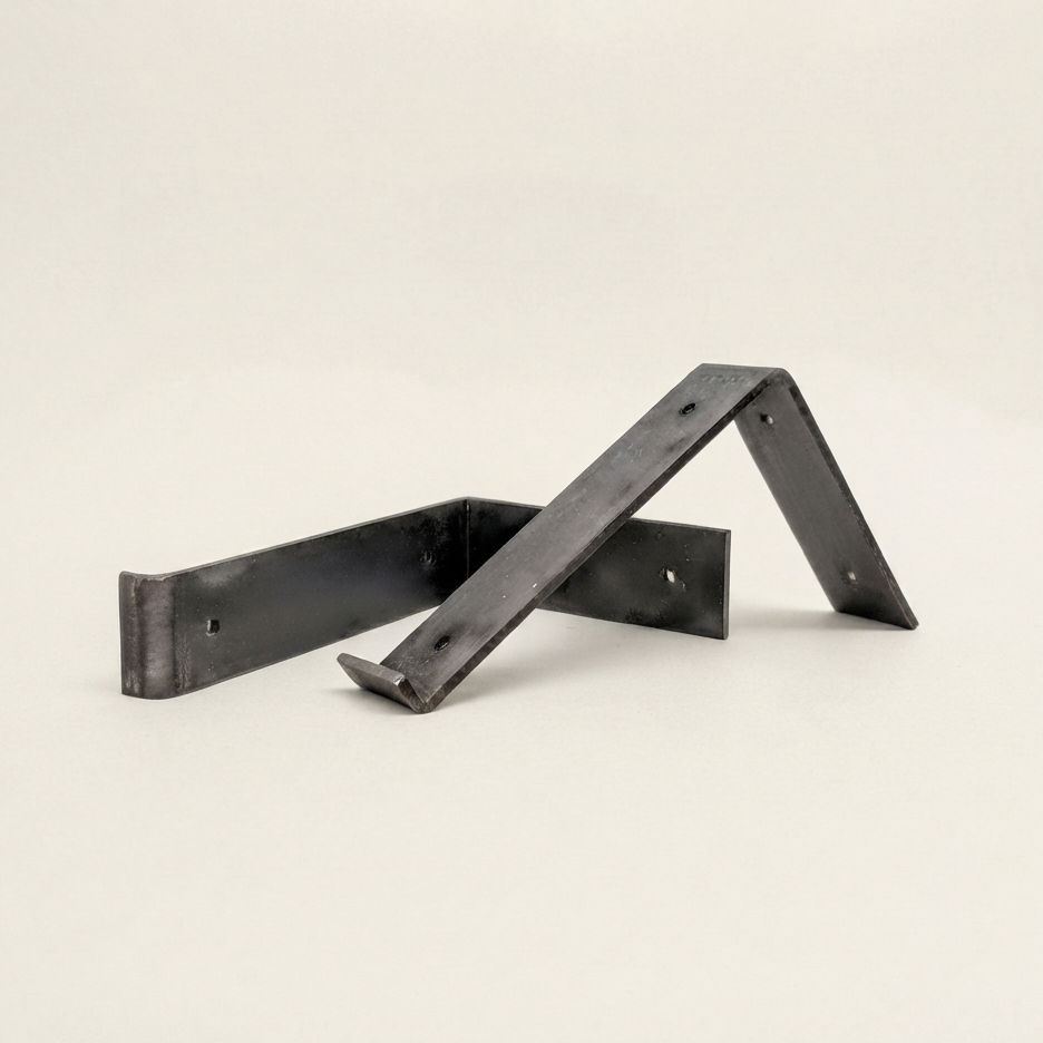A pair of black metal bracket supports with a matte finish, displayed on a clean, light off-white background.